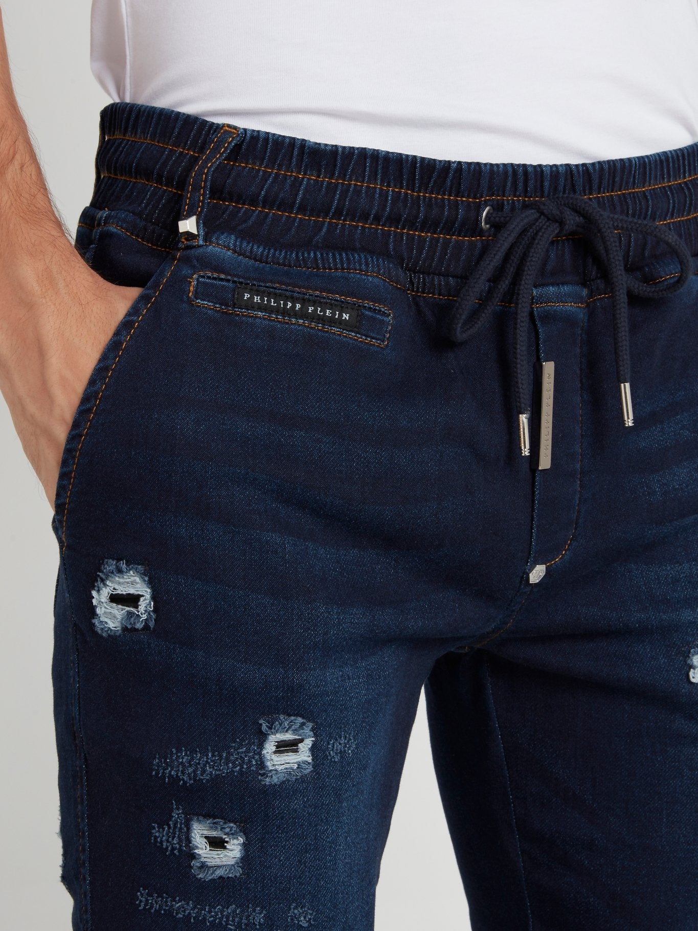 Темно-синие брюки с рваной отделкой