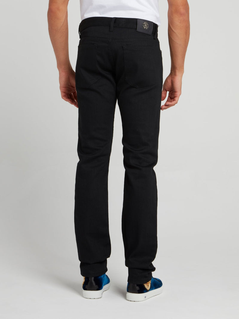 Черные джинсы с вышивкой в виде змеи