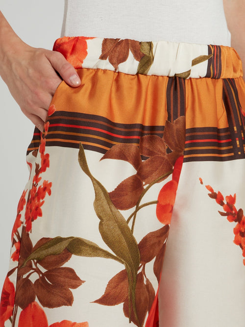 Оранжевые широкие брюки с цветочным принтом