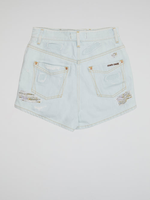 Embrace your inner rebel with our Blue Distressed Denim Shorts by Roberto Cavalli- perfect for any daring fashionista looking to make a statement. With a worn-in look and edgy vibes, these shorts are sure to turn heads wherever you go. From music festivals to beach days, these shorts are a must-have addition to your wardrobe for a bold and fearless style.