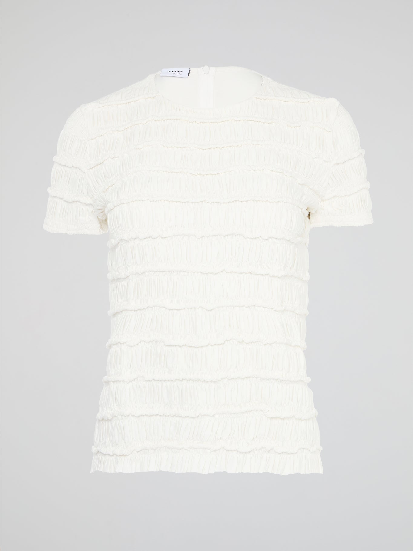 The White Tiered Top from Akris Punto is a captivating blend of sophistication and whimsy. With its unique tiered design, this versatile top adds a playful twist to any outfit. Made from premium materials, it effortlessly drapes to flatter your figure and is perfect for both casual and formal occasions.
