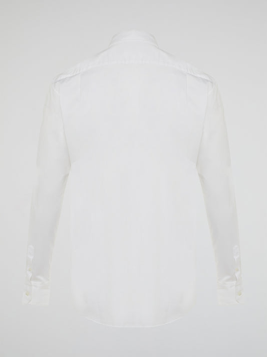 Step into a realm of elegance with the White Embroidered Shirt by Roberto Cavalli, where classic sophistication meets modern charm. Crafted with meticulous attention to detail, this shirt showcases exquisite floral embroidery that dances gracefully across the pristine white fabric. Embrace your inner fashion icon as you effortlessly blend timeless style with a touch of Italian flair, making a statement that is as timeless as it is enchanting.