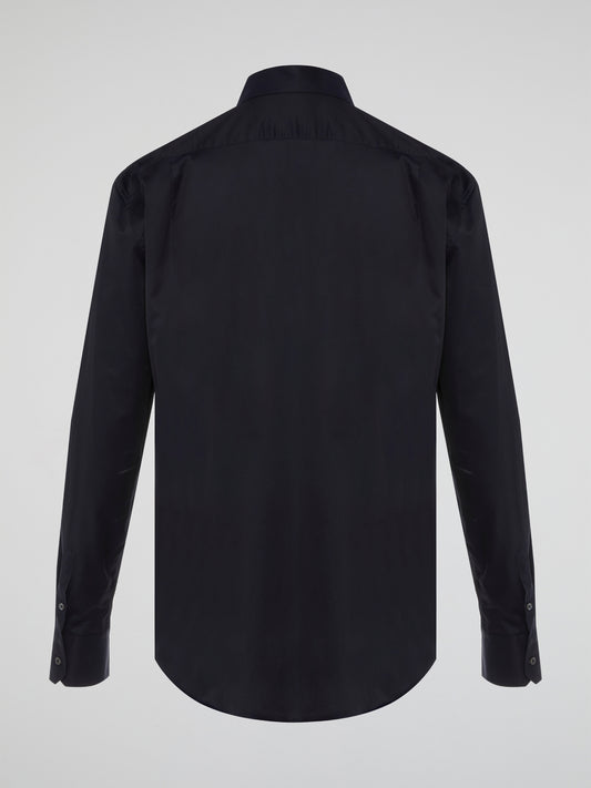 Step into the realm of effortless elegance with the captivating Black Embroidered Shirt by Roberto Cavalli. Adorned with intricate embroidery and delicate lace details, this shirt is a mesmerizing fusion of sophistication and sensuality. Elevate your style with this statement piece that exudes an air of mystique and timeless allure.