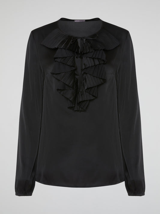 Introducing the Black Ruffle Bib Blouse by Parosh, where timeless elegance meets playful charm. Crafted with utmost precision, this statement piece features a beautifully sculpted ruffle bib that adds a touch of whimsy to your ensemble. With its sophisticated black hue and impeccable tailoring, this blouse is a must-have addition to your wardrobe, seamlessly elevating any outfit from day to night.