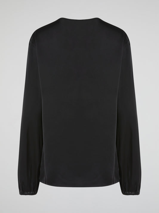 Introducing the Black Ruffle Bib Blouse by Parosh, where timeless elegance meets playful charm. Crafted with utmost precision, this statement piece features a beautifully sculpted ruffle bib that adds a touch of whimsy to your ensemble. With its sophisticated black hue and impeccable tailoring, this blouse is a must-have addition to your wardrobe, seamlessly elevating any outfit from day to night.