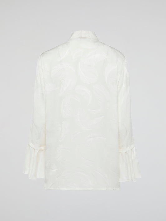 Embrace the essence of high-end fashion with the Ruffle Detailed Shirt by Roberto Cavalli. This stunning piece perfectly combines elegance and playfulness with its intricate ruffles that gracefully dance along the collar and cuffs. Crafted from luxurious materials, this shirt is a true statement piece that effortlessly elevates any outfit.