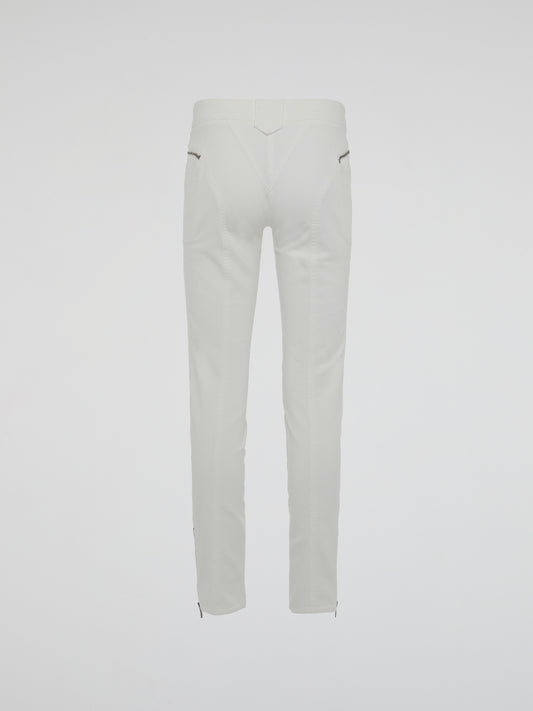 Introducing the epitome of style and sophistication - the White Zipper Detailed Trousers by Roberto Cavalli. These exquisite trousers blend modern minimalism with edgy details, boasting a sleek white hue that exudes elegance. The alluring zipper accents strategically placed throughout add a touch of rebellious charm, making these trousers a true fashion statement.
