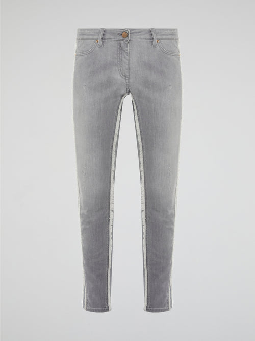 Elevate your denim game with these Grey Fringe Detailed Jeans from Roberto Cavalli. With intricate fringe detailing down the sides, these jeans offer a modern twist on a classic wardrobe staple. Pair them with a sleek top and statement heels for a look that's sure to turn heads.