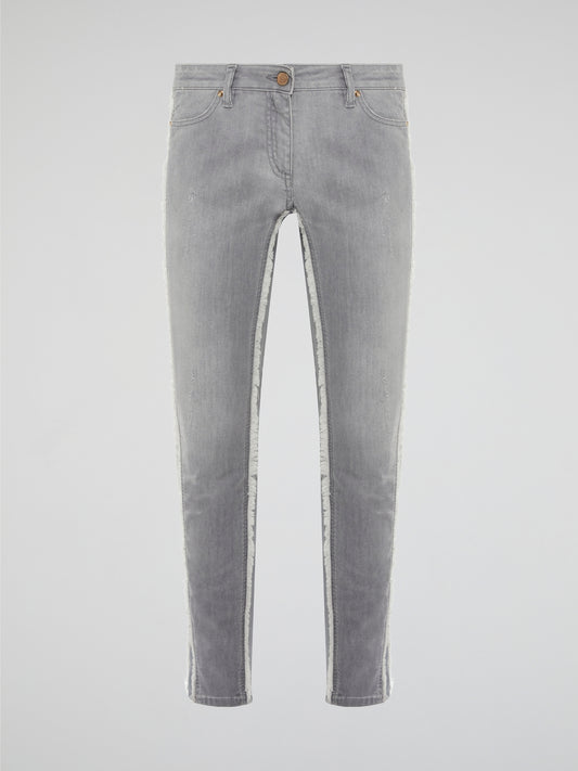 Elevate your denim game with these Grey Fringe Detailed Jeans from Roberto Cavalli. With intricate fringe detailing down the sides, these jeans offer a modern twist on a classic wardrobe staple. Pair them with a sleek top and statement heels for a look that's sure to turn heads.
