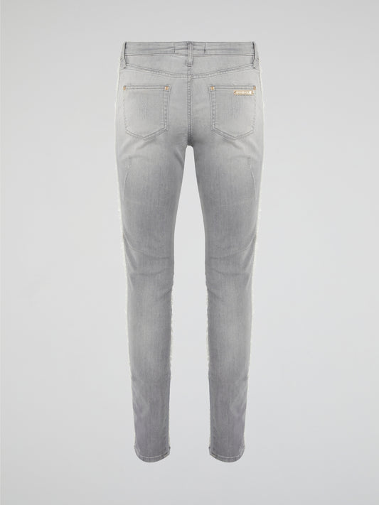 Elevate your denim game with these Grey Fringe Detailed Jeans from Roberto Cavalli. With intricate fringe detailing down the sides, these jeans offer a modern twist on a classic wardrobe staple. Pair them with a sleek top and statement heels for a look that's sure to turn heads.