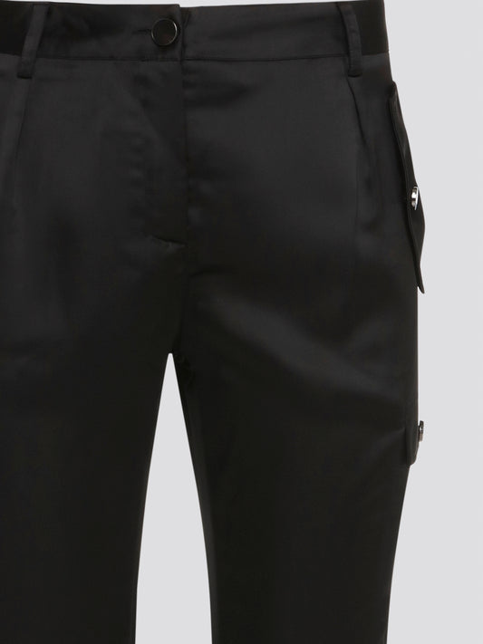 Elevate your everyday look with these sleek and stylish Black Cargo Pants from Roberto Cavalli. Made with premium quality materials, these pants are not only comfortable but also durable for long-lasting wear. With their trendy cargo pockets and tapered fit, they are the perfect statement piece for any fashion-forward individual.