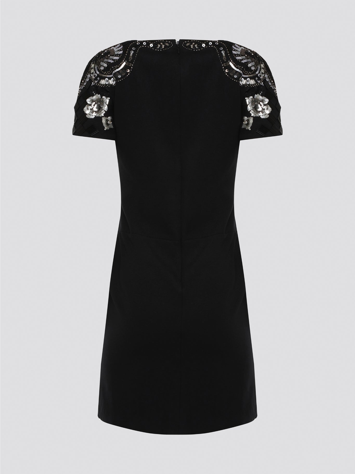 Step out in style and sophistication with our Black Embellished Plunge Dress by Roberto Cavalli. This stunning piece features intricate beadwork and shimmering embellishments that are sure to turn heads. The plunging neckline adds a touch of allure, making it the perfect choice for your next special occasion. Elevate your wardrobe with this show-stopping dress that exudes luxury and glamour.
