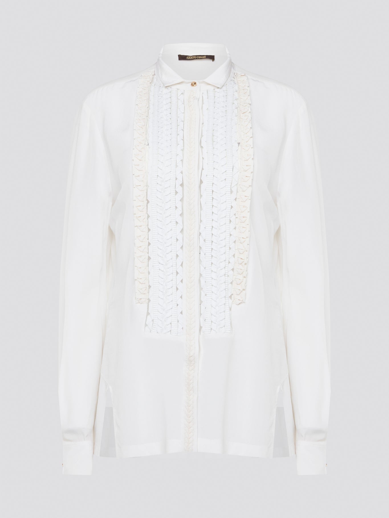 Elevate your wardrobe with this stunning Roberto Cavalli white detailed long sleeve shirt. Crafted with exquisite attention to detail, this shirt features intricate embroidery and embellishments that exude luxury and elegance. Perfect for adding a touch of sophistication to any ensemble, this statement piece is sure to turn heads wherever you go.