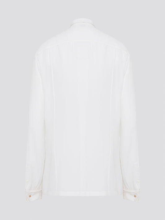 Elevate your wardrobe with this stunning Roberto Cavalli white detailed long sleeve shirt. Crafted with exquisite attention to detail, this shirt features intricate embroidery and embellishments that exude luxury and elegance. Perfect for adding a touch of sophistication to any ensemble, this statement piece is sure to turn heads wherever you go.