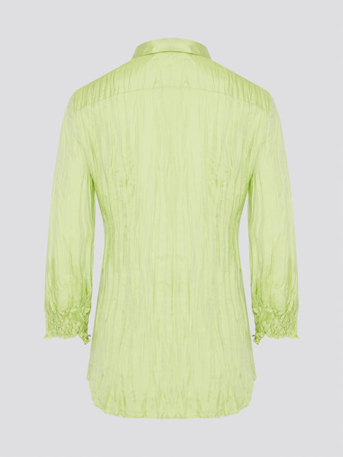 Step into the wild side with this striking green crinkled shirt from Roberto Cavalli. The vibrant hue and unique texture of the fabric will ensure you stand out from the crowd wherever you go. Embrace your fearless fashion sense and unleash your inner style icon with this must-have statement piece.