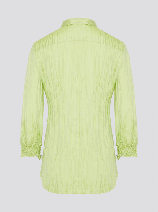 Step into the wild side with this striking green crinkled shirt from Roberto Cavalli. The vibrant hue and unique texture of the fabric will ensure you stand out from the crowd wherever you go. Embrace your fearless fashion sense and unleash your inner style icon with this must-have statement piece.