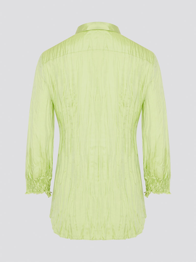 Step into the wild side with this striking green crinkled shirt from Roberto Cavalli. The vibrant hue and unique texture of the fabric will ensure you stand out from the crowd wherever you go. Embrace your fearless fashion sense and unleash your inner style icon with this must-have statement piece.