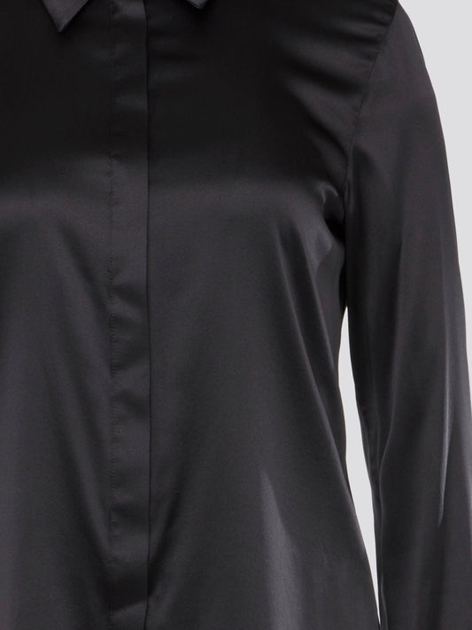 Step out in sleek and sophisticated style with this black satin shirt from Roberto Cavalli, a luxurious addition to your wardrobe. The silky smooth fabric drapes effortlessly, while the tailored fit adds a touch of elegance to any outfit. Perfect for a night out on the town or a special event, this shirt is sure to turn heads and make a statement.