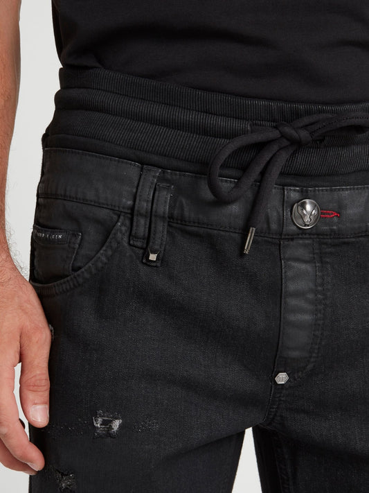 Черные джинсы на шнуровке с рваной отделкой