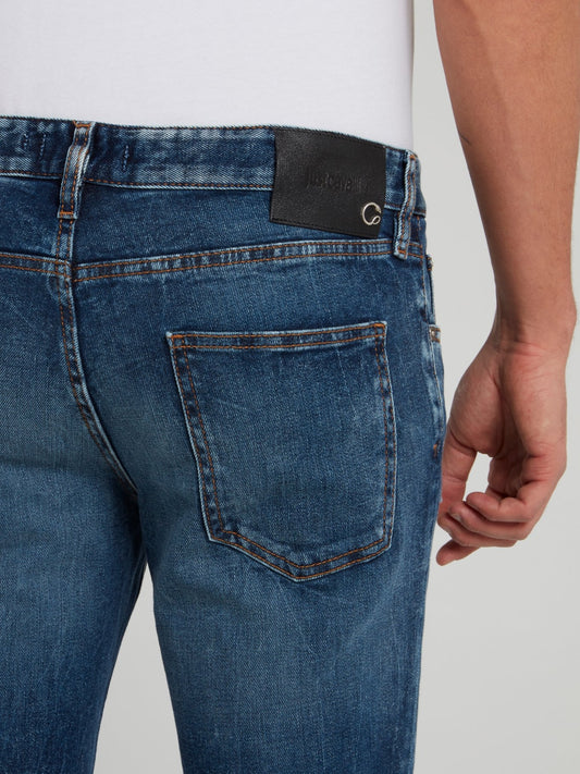 Синие зауженные джинсы с рваной отделкой