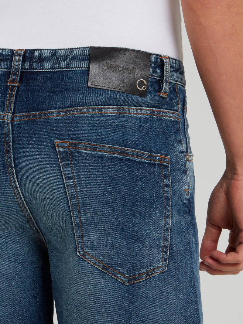 Синие джинсовые шорты с рваной отделкой