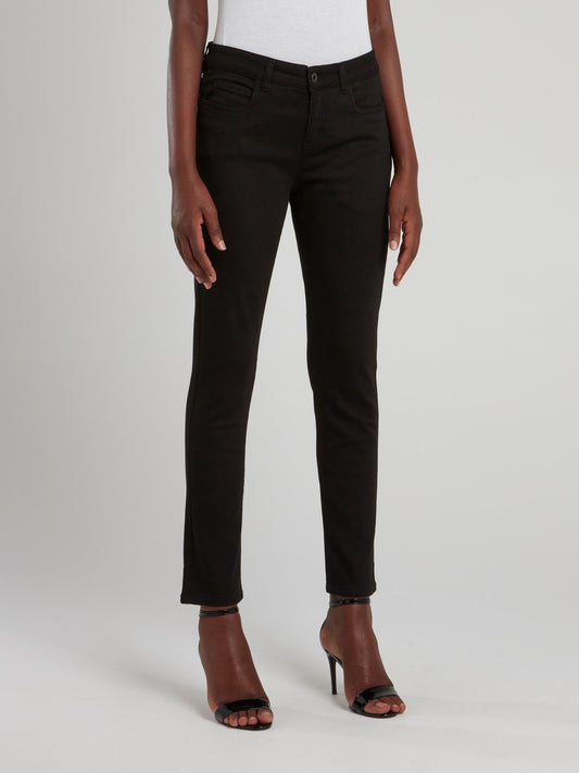 Черные брюки с декором на карманах