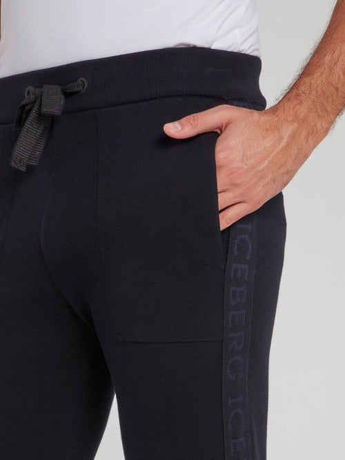 Темно-синие трикотажные брюки с логотипом на лампасах