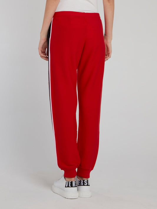 Красные трикотажные брюки с логотипом на лампасах